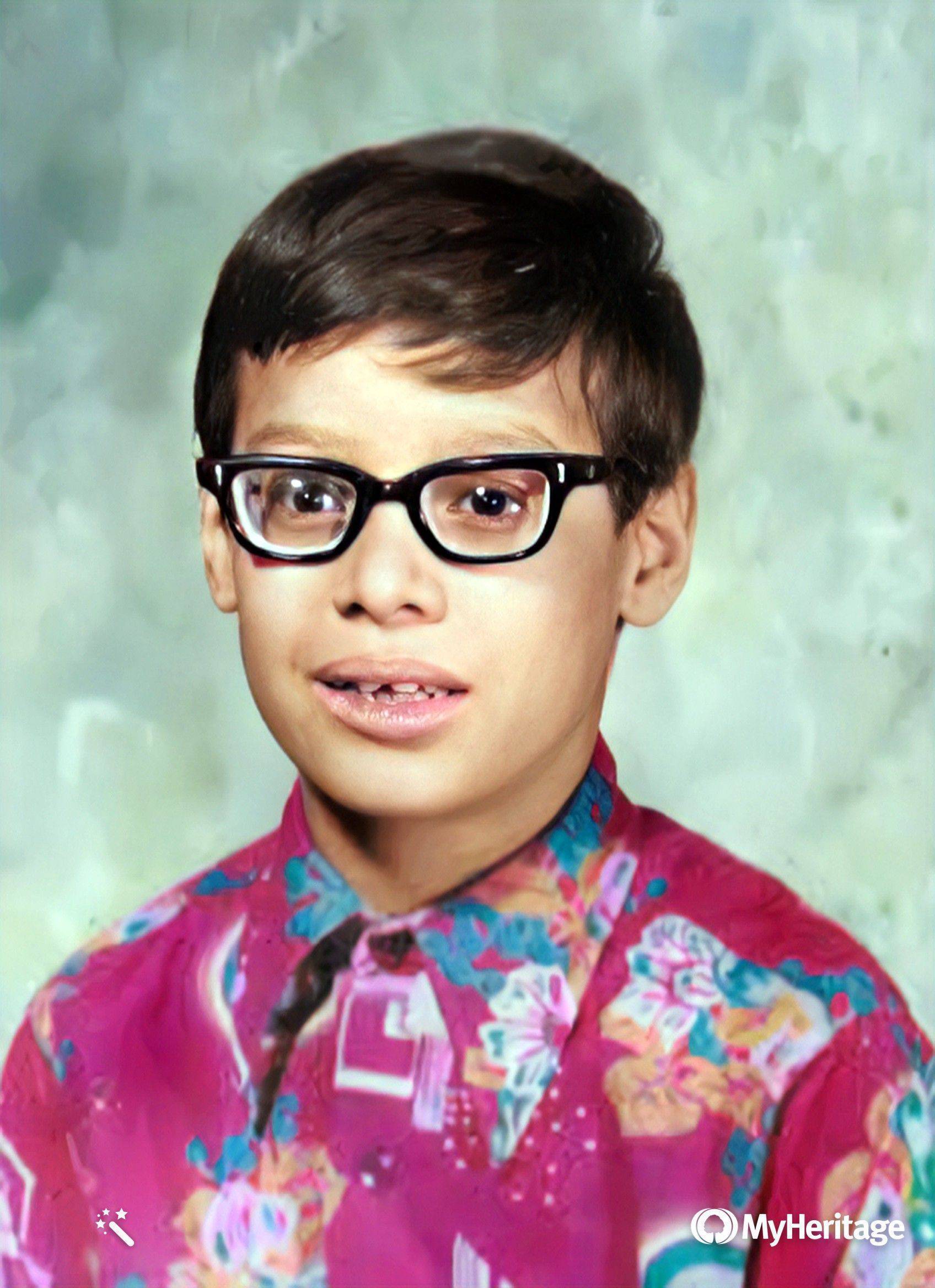 Victor Claudio wearing thick glasses at age five