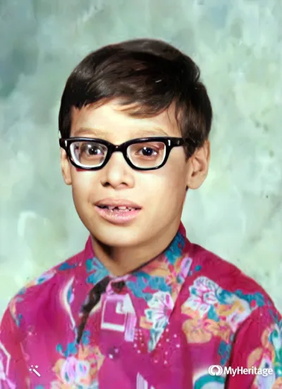 Victor Claudio wearing thick glasses at age five